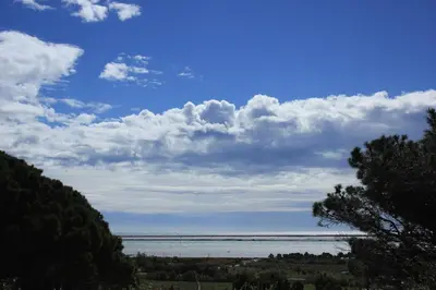a view of the ocean under a cloudy sky at La Poussada, maisons écologiques avec vue mer in Lapalme