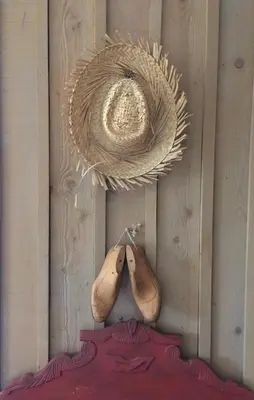 a pair of shoes hanging on a wall at La Poussada, maisons écologiques avec vue mer in Lapalme