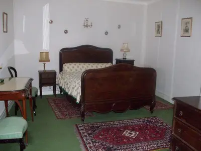 a bedroom with a bed and a table with two lamps at Le Domaine Du Chapitre in Carcassonne