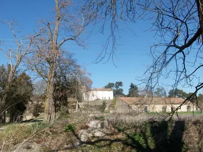 a view of a field with trees and buildings at Le Domaine Du Chapitre in Carcassonne