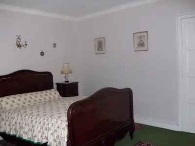 a bedroom with a bed and a lamp and a window at Le Domaine Du Chapitre in Carcassonne