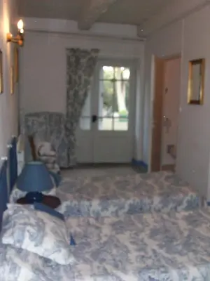 a bedroom with a bed and a window and a door at Le Domaine Du Chapitre in Carcassonne