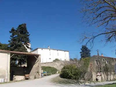 a building on a hill next to a street at Le Domaine Du Chapitre in Carcassonne