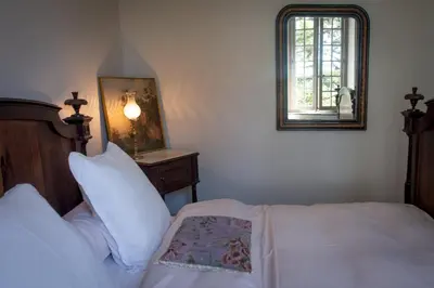 a bedroom with a bed and a mirror on the wall at Château de Puichéric in Puicheric