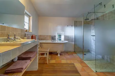 a bathroom with a tub and a sink and a shower at Château de Puichéric in Puicheric