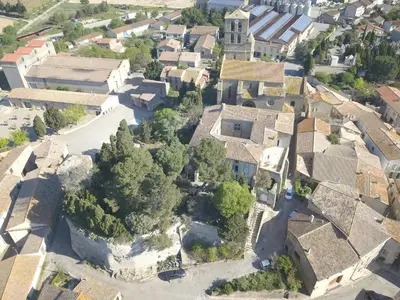 an aerial view of a village with a church at Château de Puichéric in Puicheric