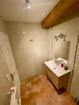 a bathroom with a sink and a mirror at La Prade des 