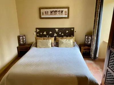 a bedroom with a large bed with birds on it at La Prade des 