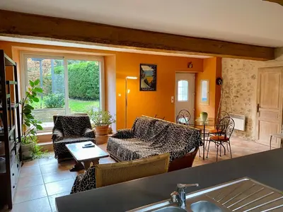 a living room with a couch and a table at La Prade des 