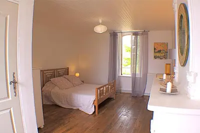 a bedroom with a bed and a window at Gite La Luciole in Tourtrol