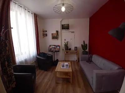 a living room with a couch and a table at Hotel Astoria in Carcassonne