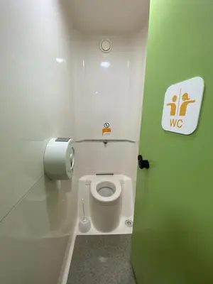 a bathroom with a toilet with a toilet paper dispenser at Hotel Class'Eco Carcassonne in Carcassonne