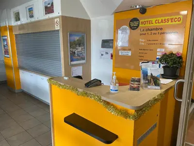 a yellow counter in a store with a phone on it at Hotel Class'Eco Carcassonne in Carcassonne