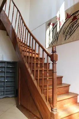 a wooden staircase in a home with wooden floors at Maison d'hôtes Saint Alary in Lavaur