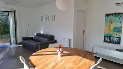 a living room with a table and a couch at location Silvis dans la propriété Elaia in Tourouzelle