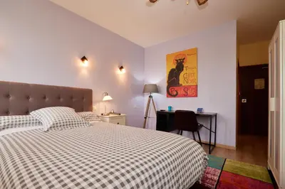a bedroom with a bed and a desk in it at hotel de la paix in Pamiers