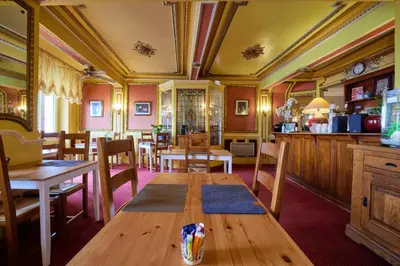 a dining room with a wooden table and chairs at hotel de la paix in Pamiers