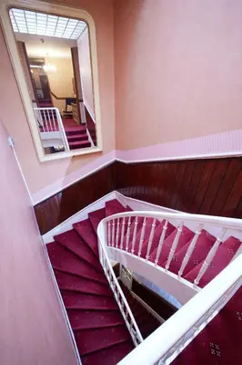 a view of a staircase with a mirror and a mirror at hotel de la paix in Pamiers