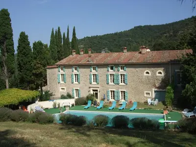 a large house with a swimming pool in front of it at Domaine Saint Andrieu in Greffeil