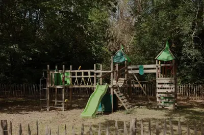 a wooden playground with a slide and a slideintend at Chateau de Blomac in Blomac
