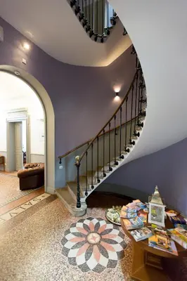 a living room with a spiral staircase and a table at Chateau de Blomac in Blomac