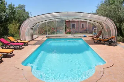 a swimming pool with a cover over it at Lou Daro in Cébazan