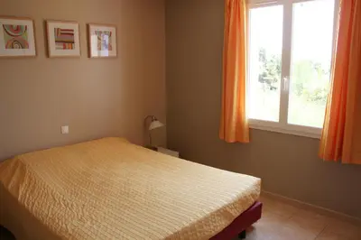 a bedroom with a bed and a window at Lou Daro in Cébazan