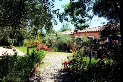 a garden in front of a house with flowers at Lou Daro in Cébazan