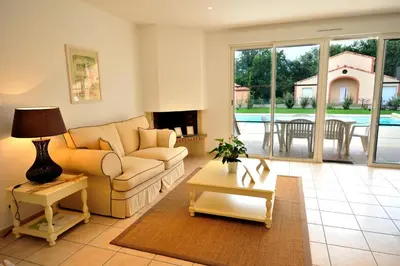 a living room with a couch and a table at Lagrange Vacances - Royal Green in Pont-de-Larn