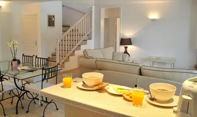 a living room with a couch and a table with glasses of orange juice at Lagrange Vacances - Royal Green in Pont-de-Larn