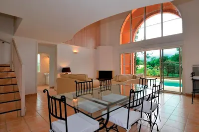 a living room with a glass table and chairs at Lagrange Vacances - Royal Green in Pont-de-Larn