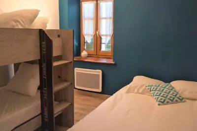 a bedroom with a bunk bed and a window at Le Leon d'or in Mirepoix