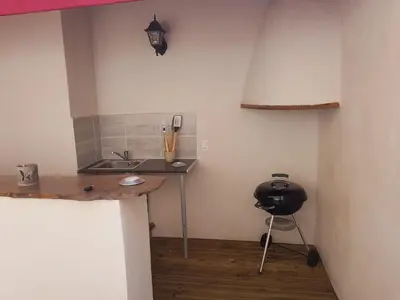 a kitchen with a sink and a chair in a room at Le Leon d'or in Mirepoix