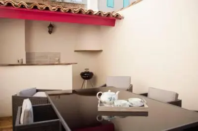 a table with two tea pots on top of it at Le Leon d'or in Mirepoix