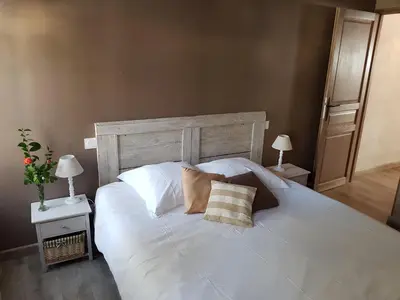 a large white bed with two pillows on it at Le Leon d'or in Mirepoix