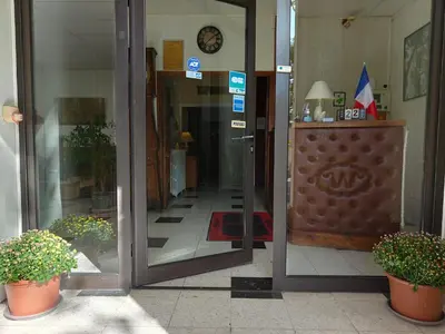 an open glass door of a building with potted plants at Will's Hotel in Narbonne