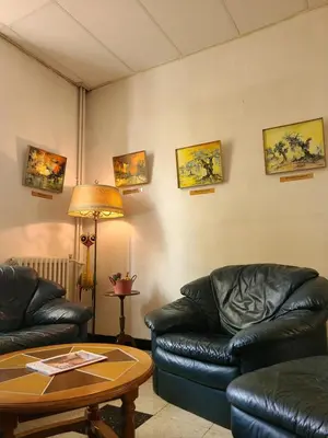 a waiting room with leather couches and a table at Will's Hotel in Narbonne