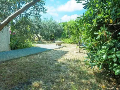 a garden with a bench next to some fruit trees at Chic Narbonne Pool Retreat in Narbonne