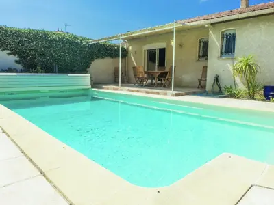 a swimming pool in front of a house at Chic Narbonne Pool Retreat in Narbonne