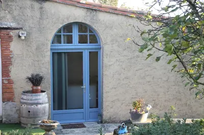 a blue door on the side of a building at La Bleuette in Montmaur