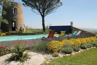 a garden with colorful flowers next to a pool at La Bleuette in Montmaur