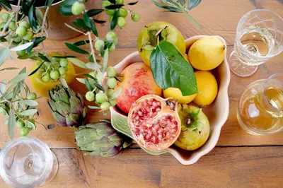 a bowl of fruit and vegetables on a wooden table at LOFT - Powered by LIEU - in Villedaigne