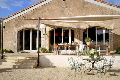 a table and chairs in front of a building at LOFT - Powered by LIEU - in Villedaigne