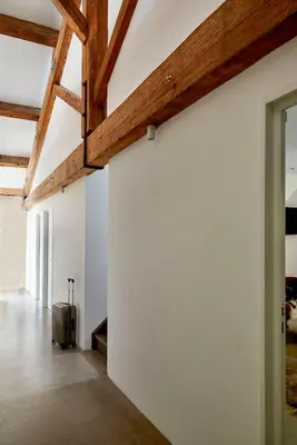 a room with a white wall and a suitcase at LOFT - Powered by LIEU - in Villedaigne