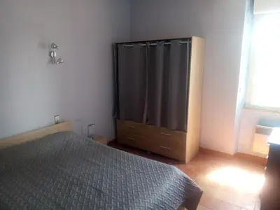 a bedroom with a bed and a dresser and a window at Château Villemagne in Lagrasse