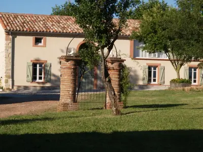 a house with a tree in front of it at Le Majeste in Juzes