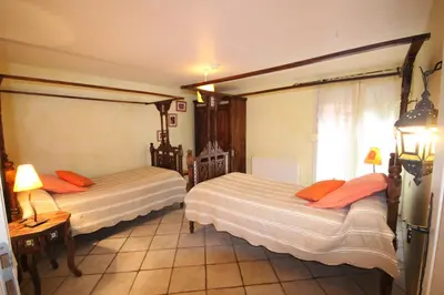 a hotel room with two beds and a window at Gîte des Orgues d'Ille les Eucalyptus in Ille-sur-Têt