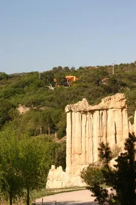 a large rock formation with a house on a hill at Gîte des Orgues d'Ille les Eucalyptus in Ille-sur-Têt