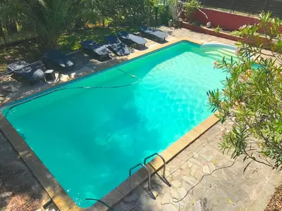 an overhead view of a swimming pool with blue water at Gîte des Orgues d'Ille les Eucalyptus in Ille-sur-Têt