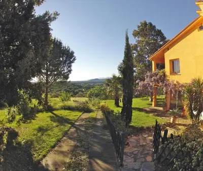 a house with a pathway leading to a yard at Gîte des Orgues d'Ille les Eucalyptus in Ille-sur-Têt